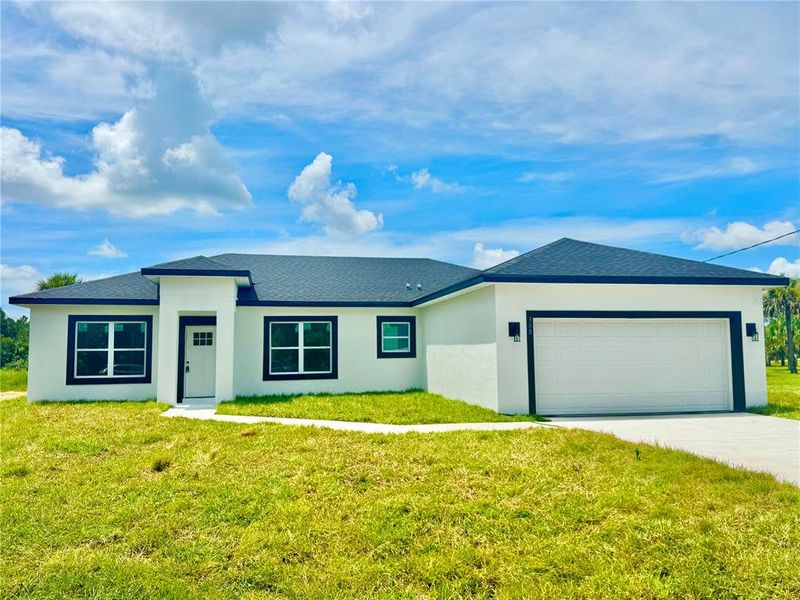 Front exterior of a new home in , Palm Bay, FL, highlighting curb appeal (Image 26).
