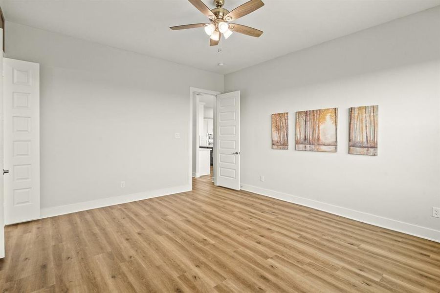 The Primary Bedroom is accessible at the end of a small hallway right off the Kitchen. With so much space, this room can easily accommodate additional furniture like a dresser, armoire, desk, or pair of cozy chairs.