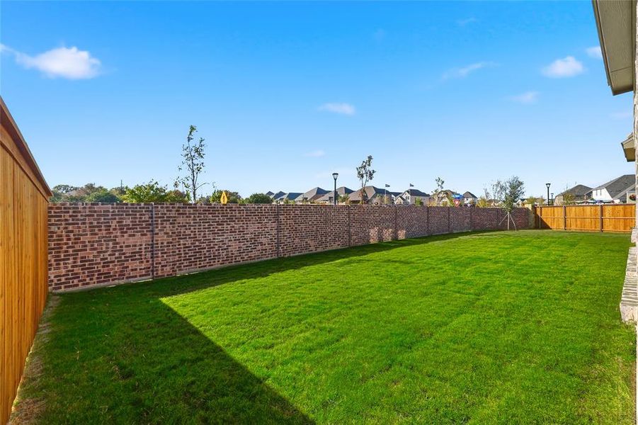 Fenced backyard with a residential view