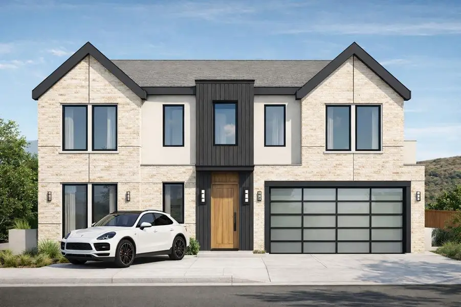 View of front facade featuring a garage and driveway View of front facade featuring a garage and driveway