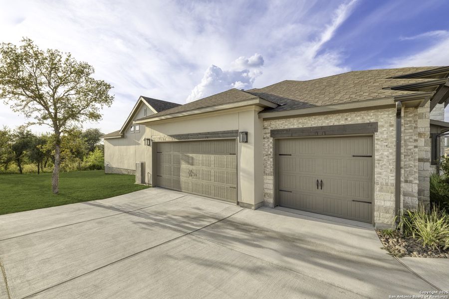Front exterior of a new home in Megan's Landing 1/2 Acre, San Antonio, TX, highlighting curb appeal (Image 23). Front exterior of a new home in Megan's Landing 1/2 Acre, San Antonio, TX, highlighting curb appeal (Image 23).