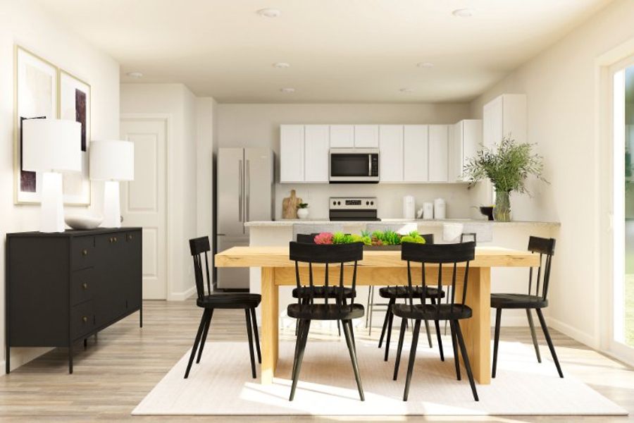 A kitchen with a dining table.