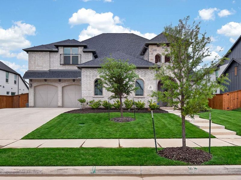 Front exterior of a new home in Light Farms Graham/Reagan, Celina, TX, highlighting curb appeal (Image 1). Front exterior of a new home in Light Farms Graham/Reagan, Celina, TX, highlighting curb appeal (Image 1).