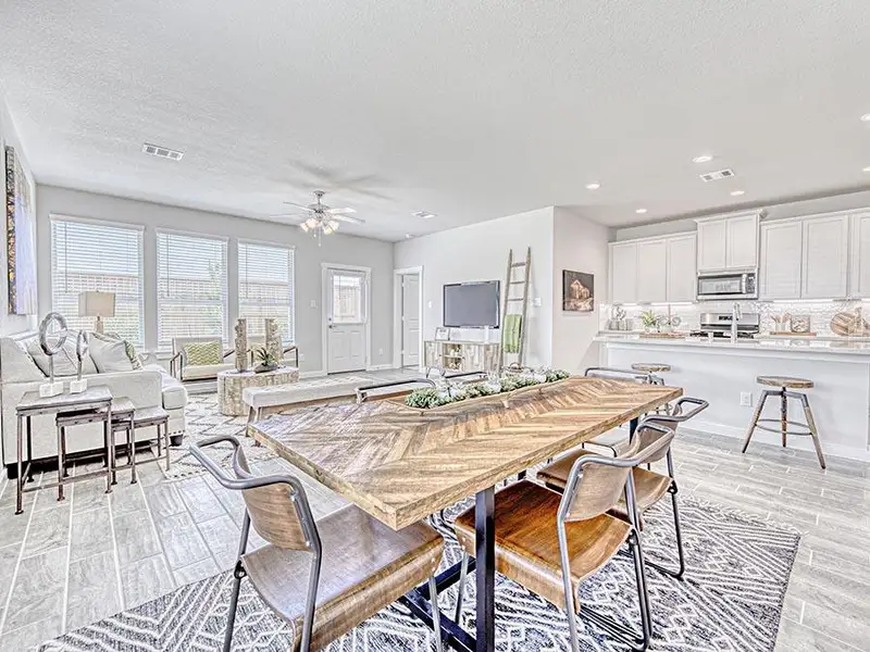 A large kitchen with a dining table.