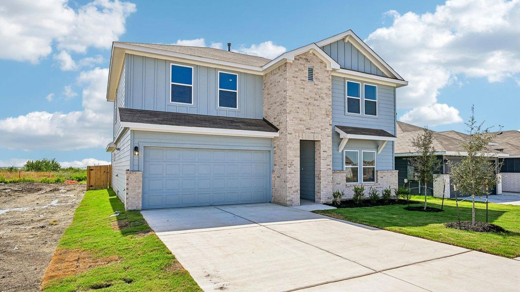 Front exterior of a new home in Carillon, Manor, TX, highlighting curb appeal (Image 20).