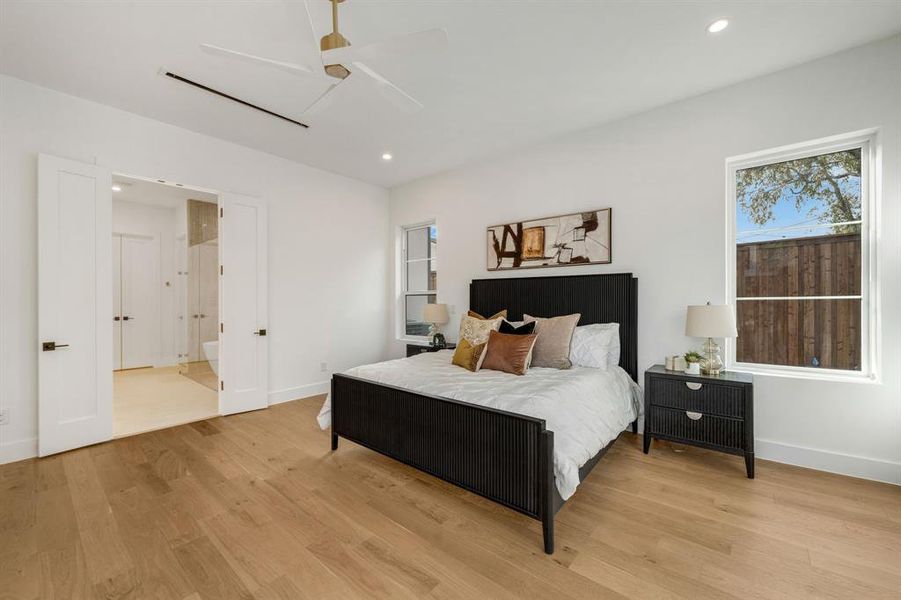 Bedroom with wood finished floors, recessed lighting, and a ceiling fan Bedroom with wood finished floors, recessed lighting, and a ceiling fan