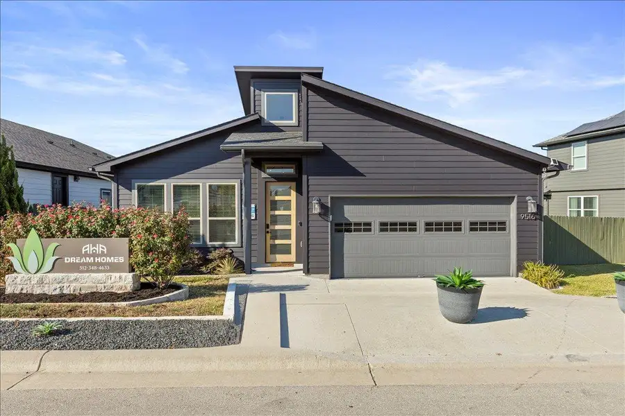 View of front of house featuring concrete driveway and an attached garage