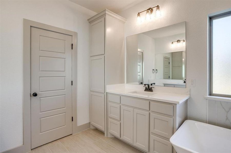 Bathroom with vanity and a bathtub