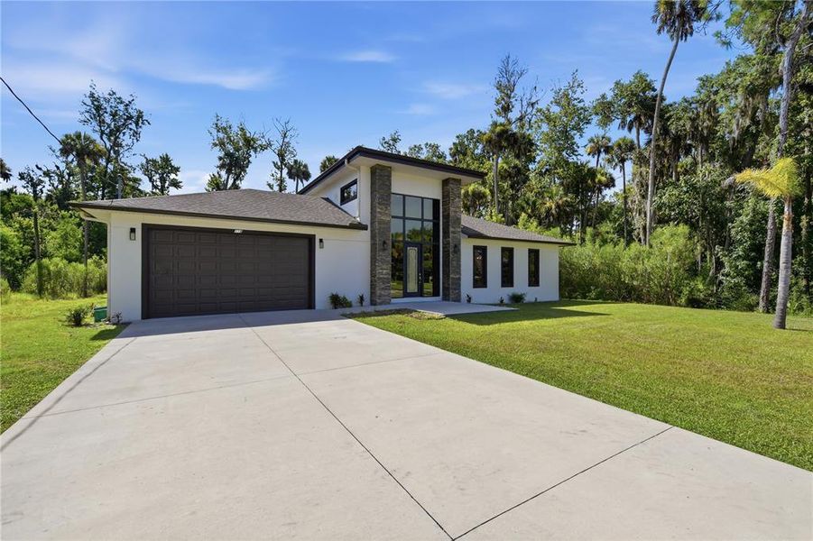 Front exterior of a new home in , Palm Coast, FL, highlighting curb appeal (Image 23). Front exterior of a new home in , Palm Coast, FL, highlighting curb appeal (Image 23).