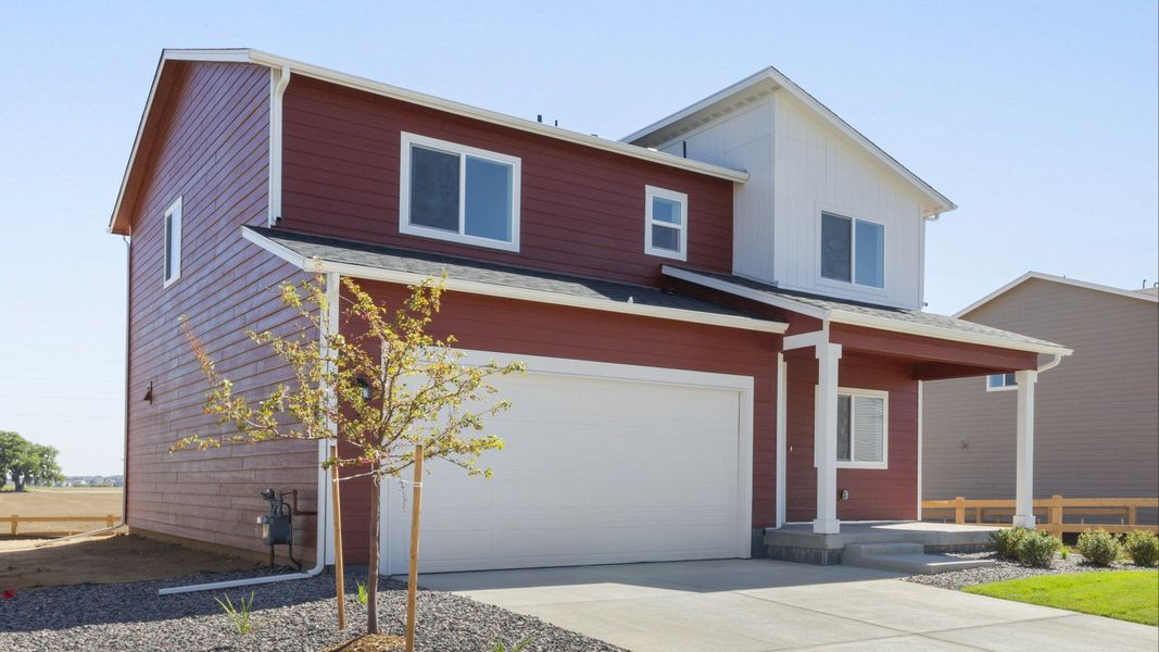 Front exterior of a new home in Granary, Johnstown, CO, highlighting curb appeal (Image 23). Front exterior of a new home in Granary, Johnstown, CO, highlighting curb appeal (Image 23).