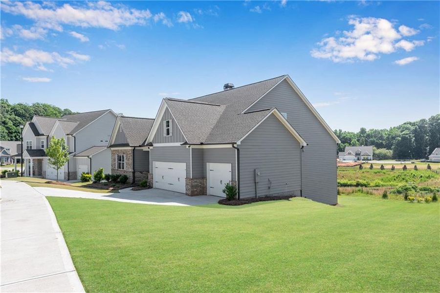 Front exterior of a new home in Hidden Fields, Hoschton, GA, highlighting curb appeal (Image 18).