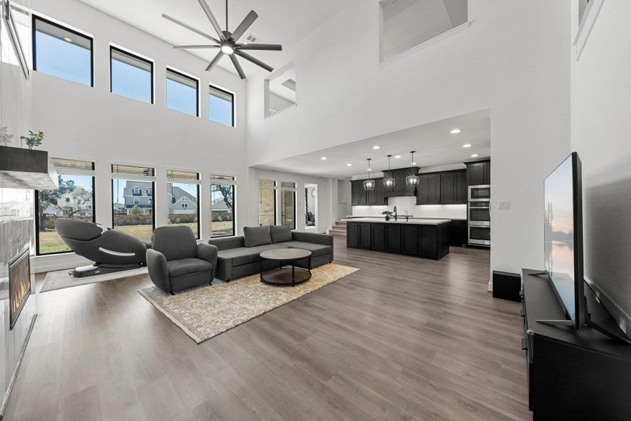 Living room featuring ceiling fan, wood finished floors, and recessed lighting