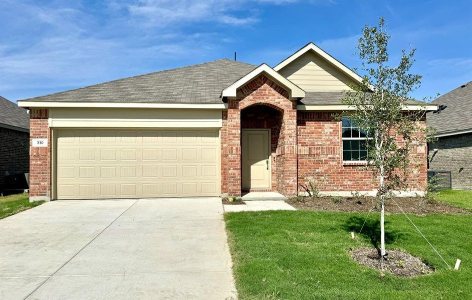 Ranch-style house featuring a garage and a front lawn