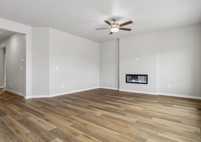 The family room is spacious with a ceiling fan and electric fireplace.