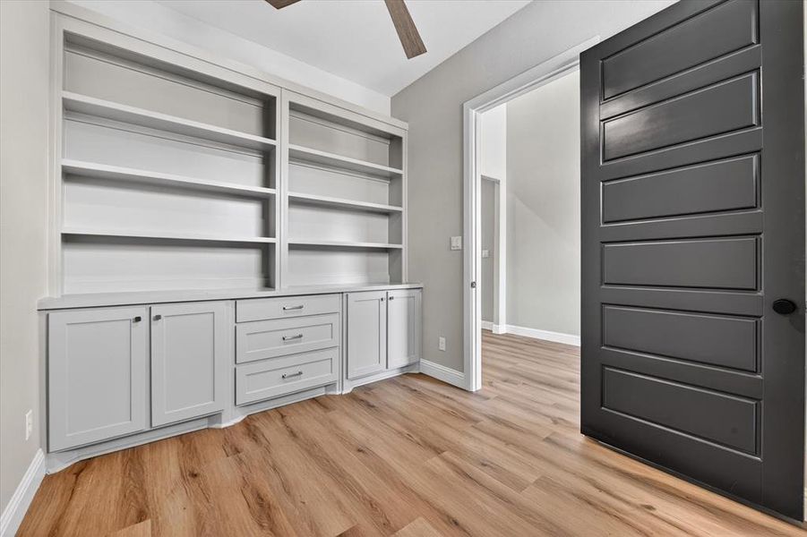 Built-in shelving and cabinetry with light gray finish