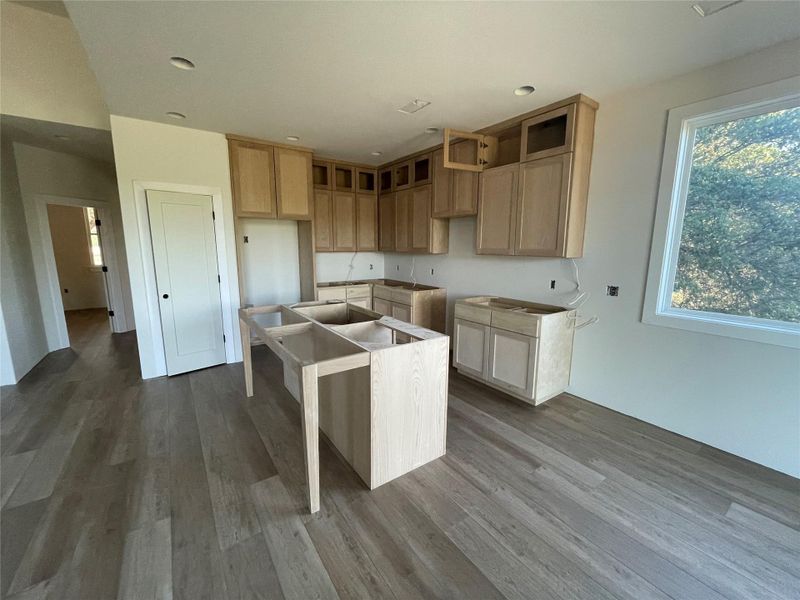 Open-concept kitchen and living space with large windows overlooking the greenbelt. Open-concept kitchen and living space with large windows overlooking the greenbelt.