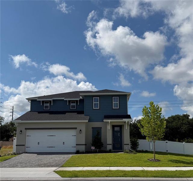 Front exterior of a new home in Yucatan Gardens, Orlando, FL, highlighting curb appeal (Image 10).