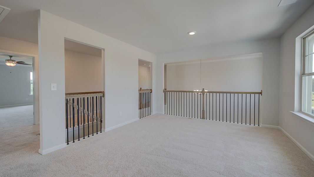 Clarity loft with carpet flooring and flexible space for work, play, or lounge at Brighton in Locust Grove, GA.