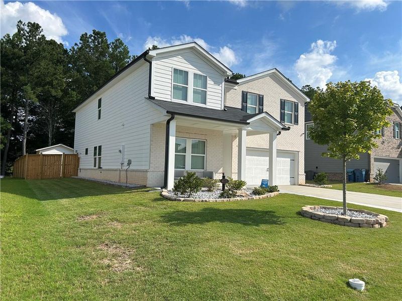 Front exterior of a new home in , Loganville, GA, highlighting curb appeal (Image 23).