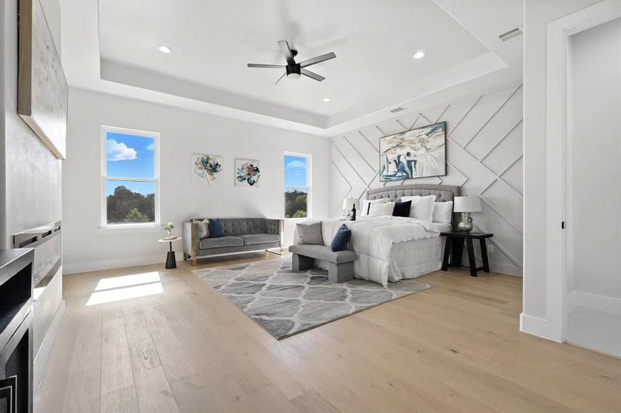 Bedroom featuring a raised ceiling, wood finished floors, recessed lighting, and ceiling fan Bedroom featuring a raised ceiling, wood finished floors, recessed lighting, and ceiling fan