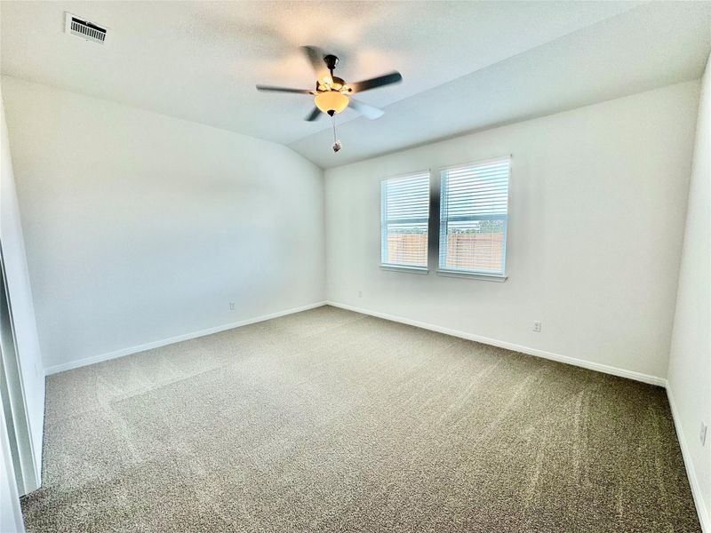 Unfurnished room featuring carpet floors, lofted ceiling, and ceiling fan