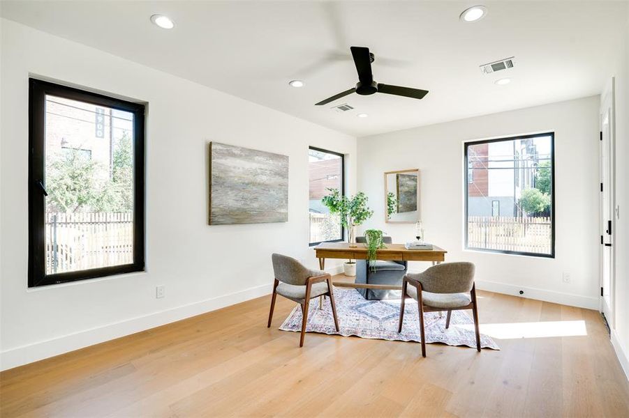 Dining room with ceiling fan, light hardwood / wood-style flooring, and plenty of natural light