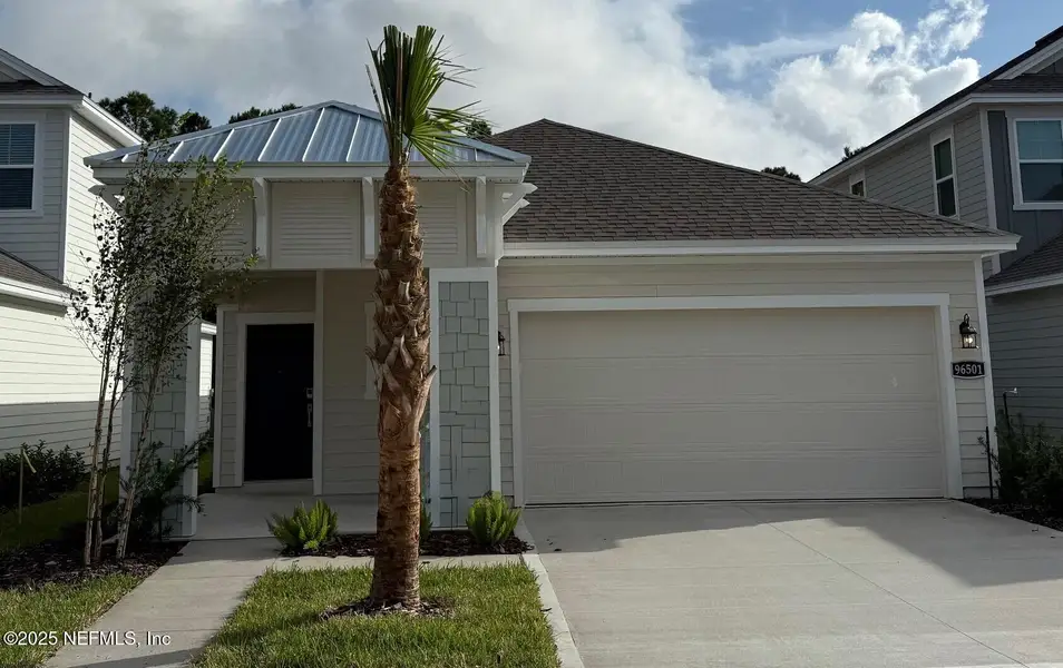 Front exterior of a new home in The Preserve at Concourse Crossing, Fernandina Beach, FL, highlighting curb appeal (Image 1).