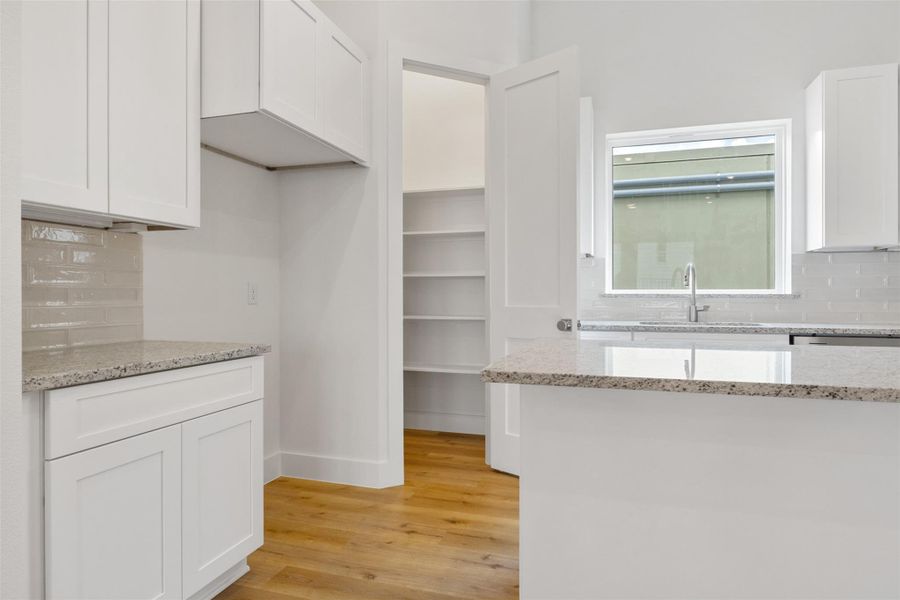 The kitchen features a spacious walk-in pantry, providing effortless storage for all your kitchen essentials. The kitchen features a spacious walk-in pantry, providing effortless storage for all your kitchen essentials.