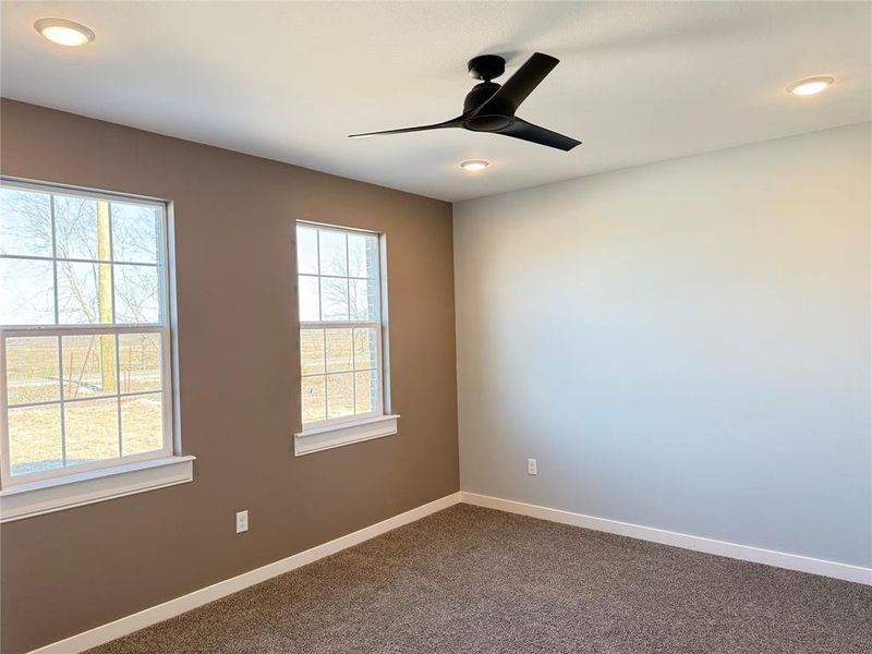 Spare room featuring carpet floors and ceiling fan