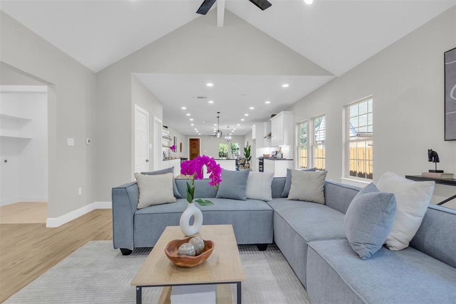 Living area with recessed lighting and light wood-style floors