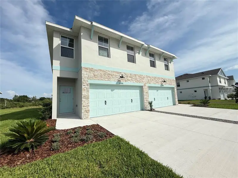 Front exterior of a new home in Emerald Fields, Hudson, FL, highlighting curb appeal (Image 2). Front exterior of a new home in Emerald Fields, Hudson, FL, highlighting curb appeal (Image 2).