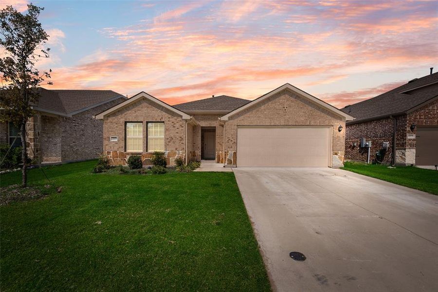 Kitchen featuring stainless steel appliances, light wood finished floors, light stone counters, decorative backsplash, and dark brown cabinets Kitchen featuring stainless steel appliances, light wood finished floors, light stone counters, decorative backsplash, and dark brown cabinets