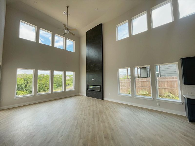 Grand living area with towering windows and a sleek fireplace, perfect for entertaining. Grand living area with towering windows and a sleek fireplace, perfect for entertaining.