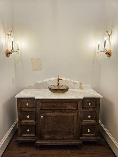Photo Update April 2026 - formal powder bath with sample of wallpaper above the sink