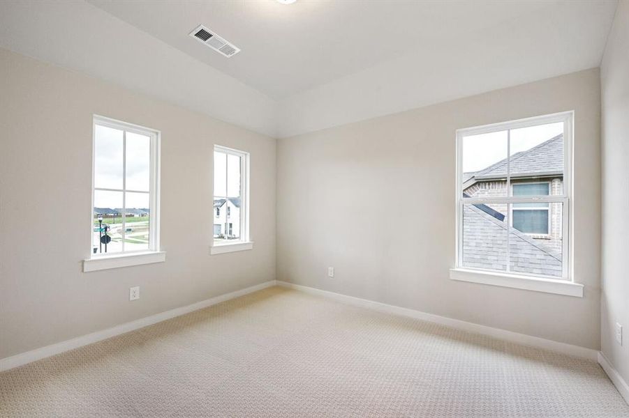 Unfurnished room featuring baseboards and light carpet