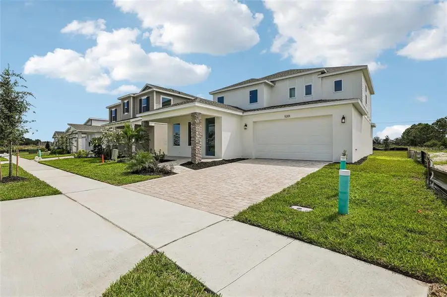 Front exterior of a new home in Lakeside at Satilla, St. Cloud, FL, highlighting curb appeal (Image 2). Front exterior of a new home in Lakeside at Satilla, St. Cloud, FL, highlighting curb appeal (Image 2).