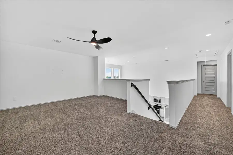 The large game room is a wonderfully versatile space and opens up to the first floor living room.