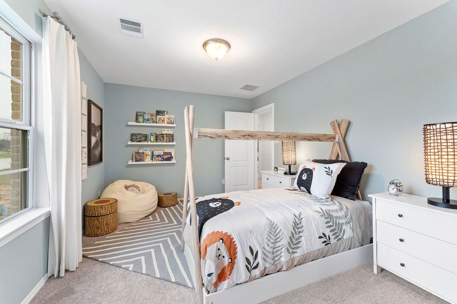 A bedroom with a bed and a shelf with books. A bedroom with a bed and a shelf with books.