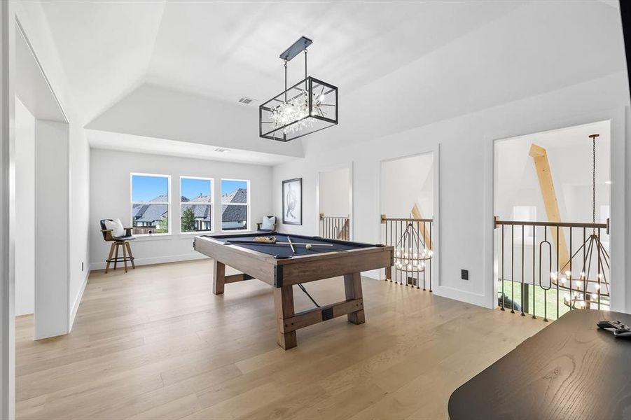 Upstairs Recreation room with a chandelier, light hardwood flooring, billiards, that overlooks the front entry and living/dining/kitchen area Upstairs Recreation room with a chandelier, light hardwood flooring, billiards, that overlooks the front entry and living/dining/kitchen area