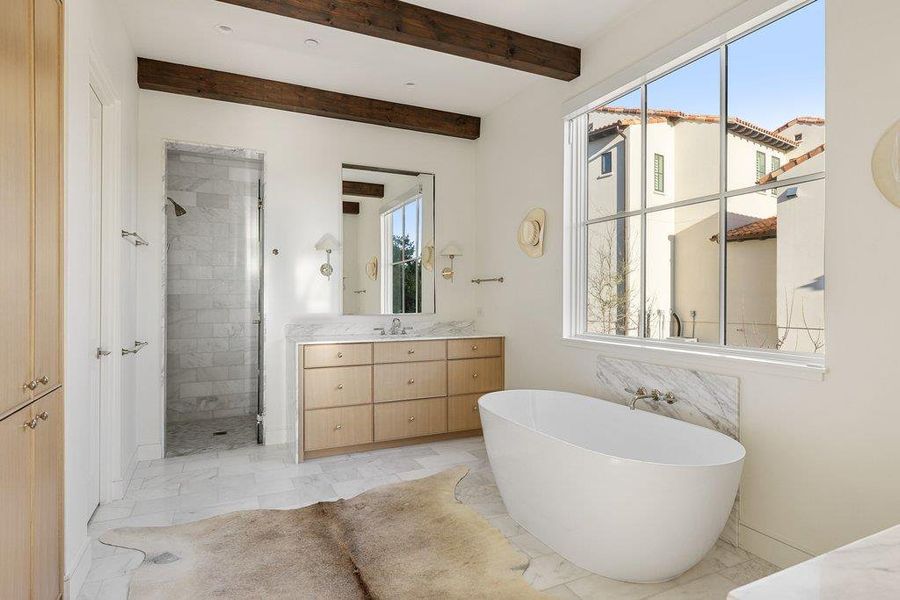 Full bathroom with vanity, a stall shower, a soaking tub, light marble finish flooring, and beam ceiling