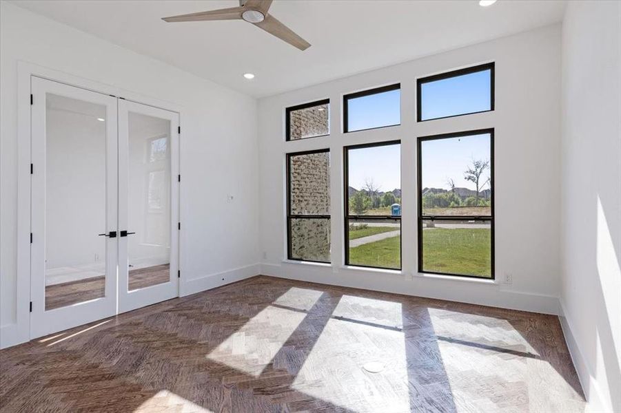 Spare room featuring ceiling fan and french doors