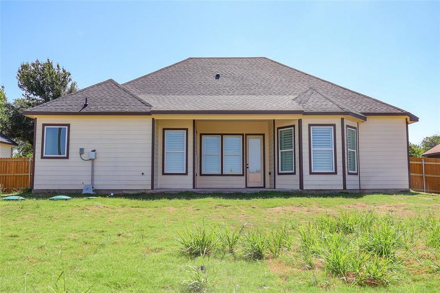 Rear view of property featuring a shingled roof Rear view of property featuring a shingled roof