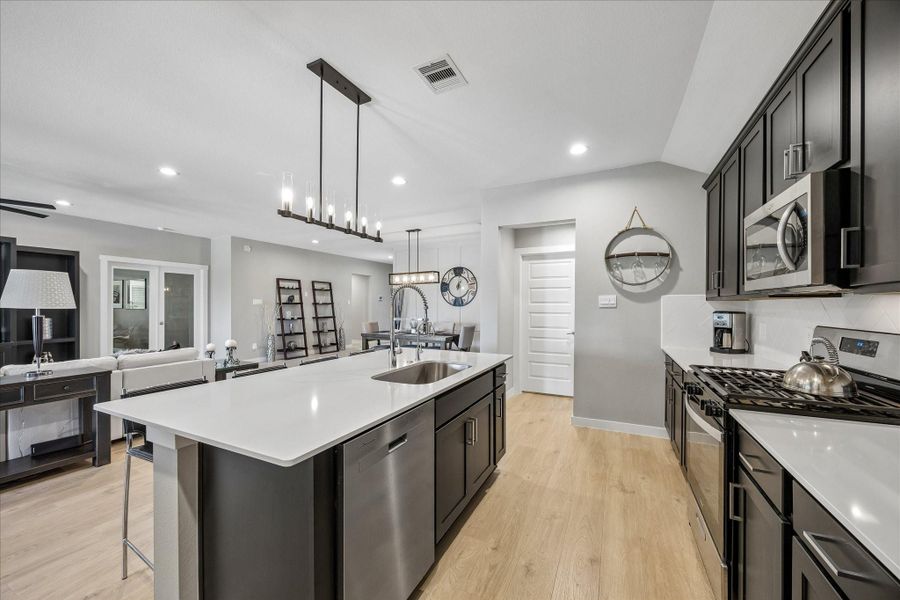 This is a view looking from refrigerator area towards the dining room and the paneled door ahead is the utility room.