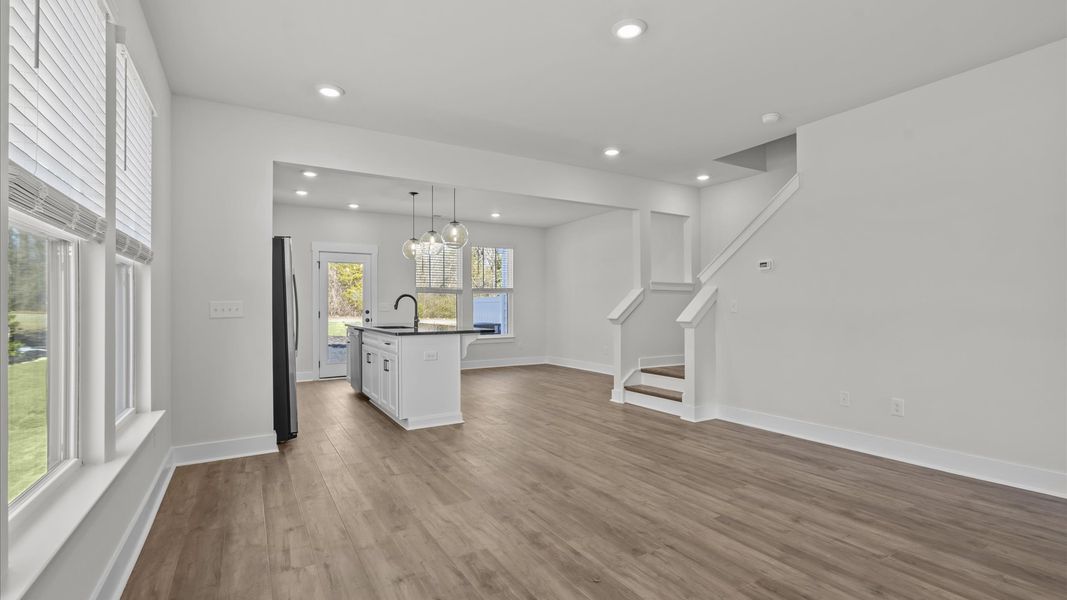 Spacious family room with rich hardwood flooring and elegant trim work in a reputable DRB Homes build