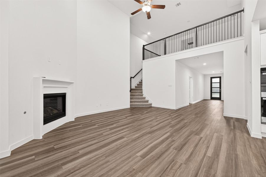 Family Room: The family room impresses with soaring ceilings and a cozy fireplace, creating a warm and welcoming atmosphere.