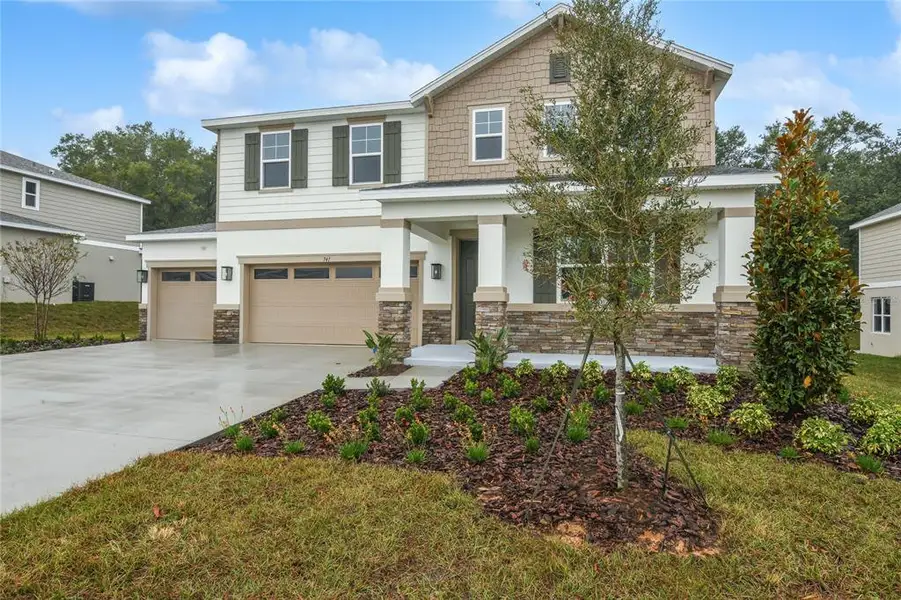 Front exterior of a new home in Seasons at Wekiva Ridge, Mount Dora, FL, highlighting curb appeal (Image 2). Front exterior of a new home in Seasons at Wekiva Ridge, Mount Dora, FL, highlighting curb appeal (Image 2).