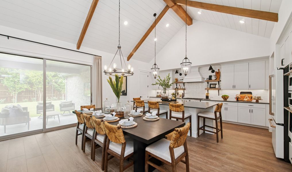 Dining area and kitchen with vaulted ceiling and stained ceiling beams Dining area and kitchen with vaulted ceiling and stained ceiling beams