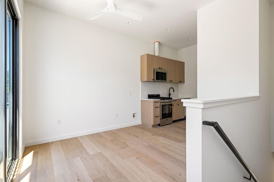 Clean lines and warm hardwood floors define this modern open-concept living space.
