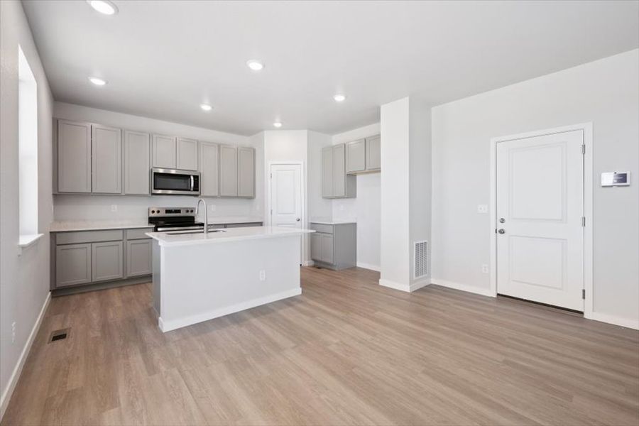 A large kitchen with white cabinets. A large kitchen with white cabinets.