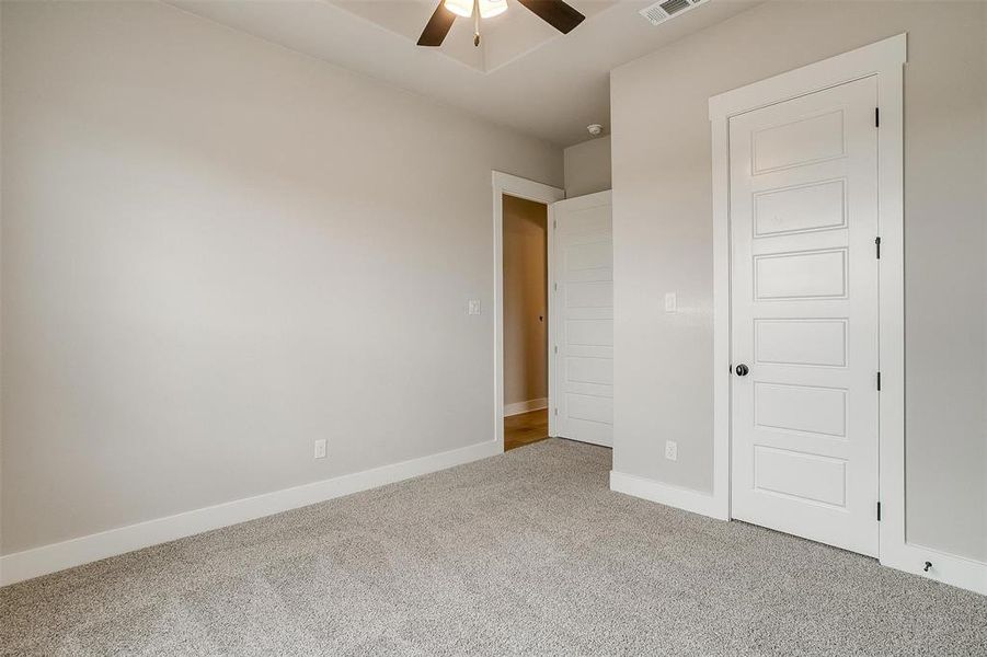 Unfurnished bedroom with carpet floors and ceiling fan